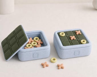 Juego de tres en raya portátil PuffGrid, caja de almacenamiento con botón pulsador, juego de mesa de centro con aspecto acolchado, 6 colores mate.