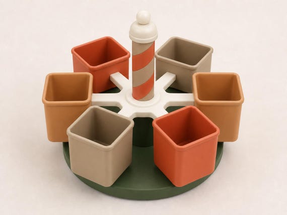 Woodland Studio rotating classroom organizer with six terracotta, caramel, and desert tan cups on a dark green base.