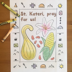 May include: A printable coloring page featuring a yellow gourd, a pink lily, and a yellow ear of corn. The page also includes the text "St. Kateri, pray for us!" and various other symbols.