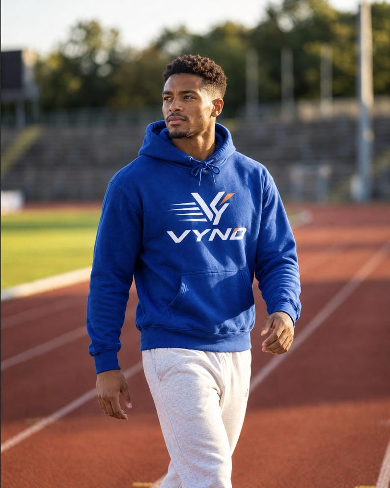 Runner in the royal blue VYND Bold Logo Hoodie on a track