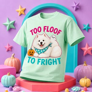 May include: A light mint green t-shirt featuring a graphic of a white Samoyed dog wearing a teal ghost-patterned bandana. The dog is next to a small orange jack-o'-lantern and a tiny ghost. The text reads TOO FLOOF TO FRIGHT in pink and teal.
