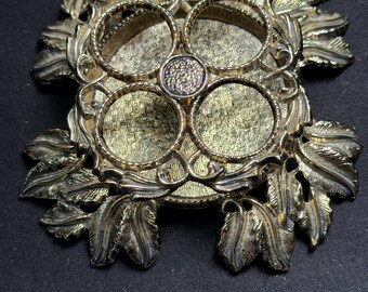Vintage gold-tone ornate leaf  metal vanity lipstick holder with four tube design.