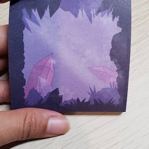 May include: A digital illustration of two pink crystals in a purple and blue landscape. The crystals are surrounded by dark purple and black jagged shapes.