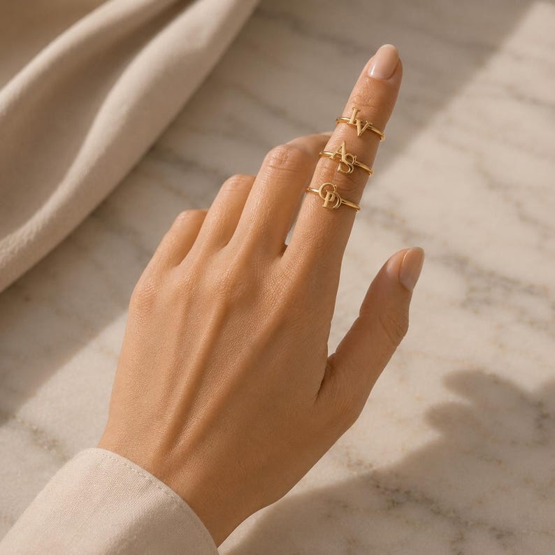 Custom initial ring featuring two connected letters in gold, romantic personalized gift for girlfriend and meaningful couple jewelry.