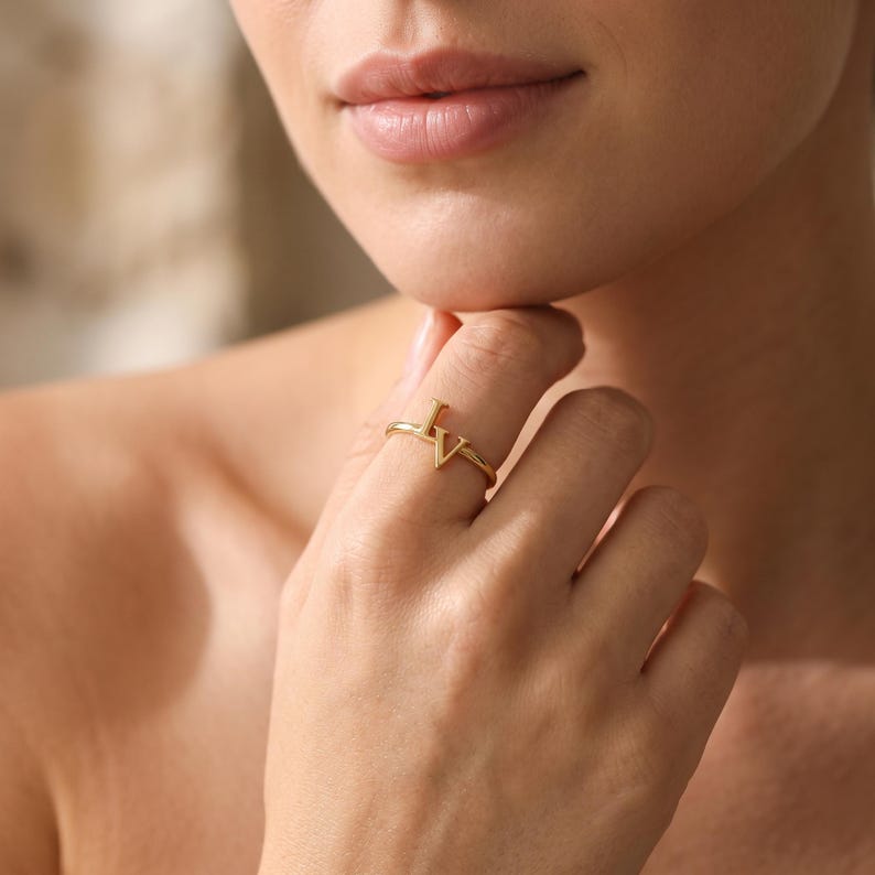 Custom couple initials ring with two intertwined letters, personalized gold jewelry symbolizing two people and their special bond.