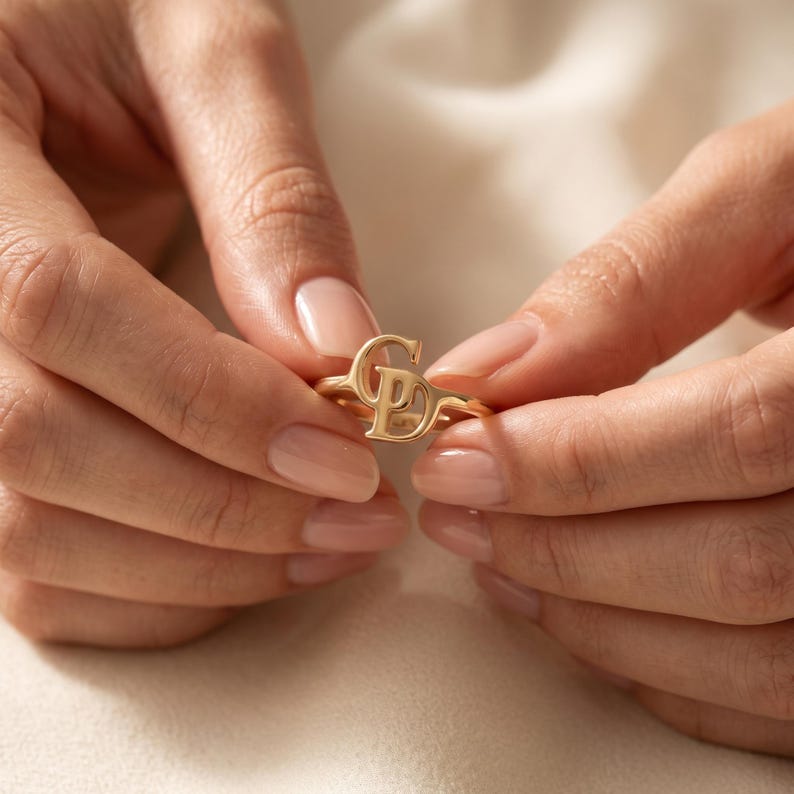 Meaningful two initial ring combining two chosen letters, sentimental personalized gold jewelry representing love, family or connection.