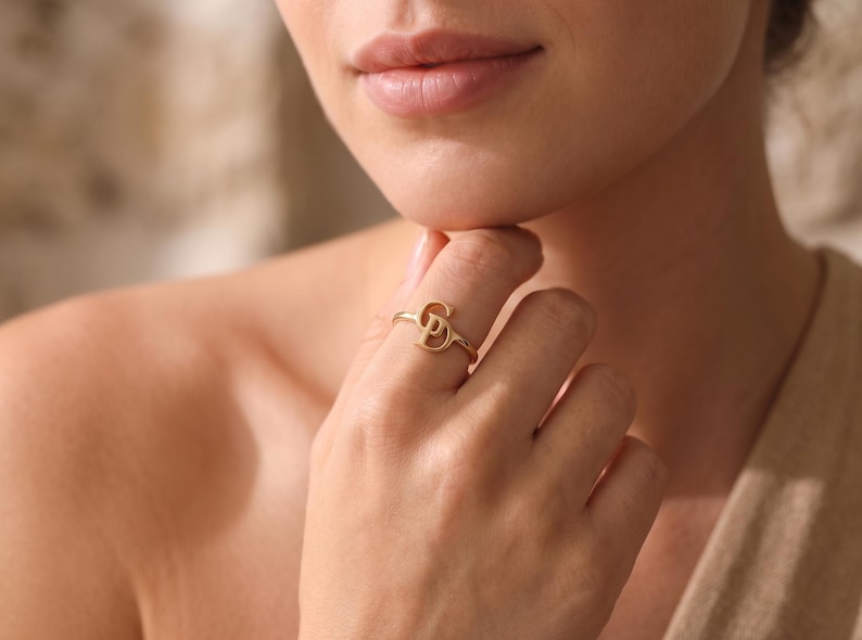 Custom double initial gold ring featuring two intertwined letters, personalized jewelry designed as a meaningful and elegant gift for her.