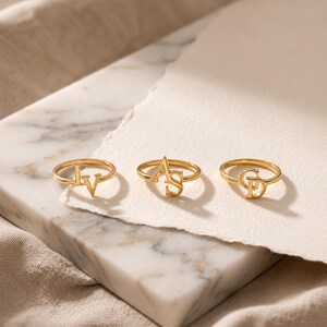 Personalized couple initial ring combining two special letters, romantic gold jewelry for couples celebrating their unique connection.