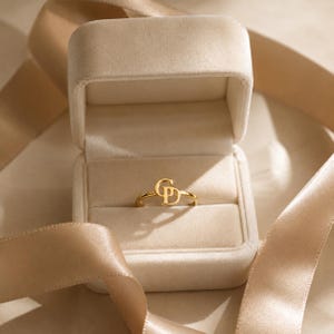 Custom gold initial ring personalized with two letters, elegant intertwined design and unique made to order jewelry for women.