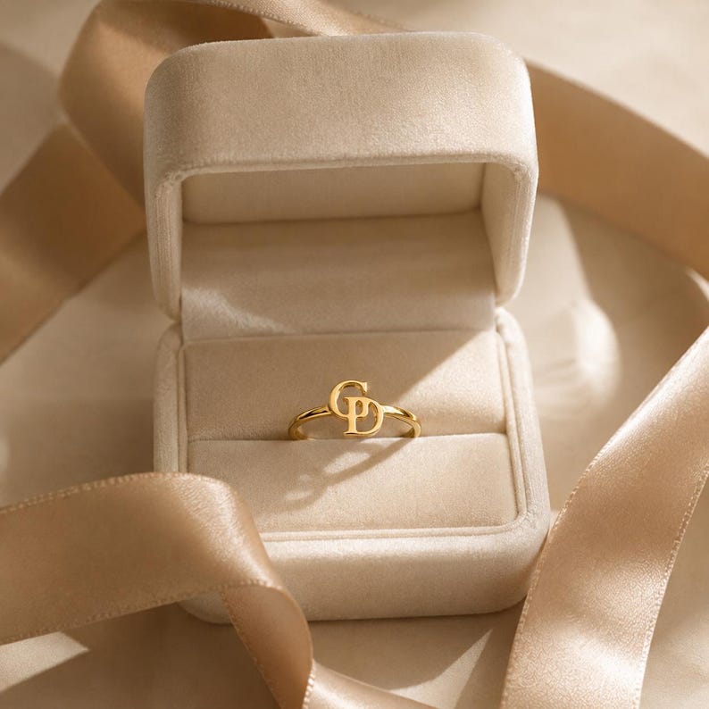 Custom gold initial ring personalized with two letters, elegant intertwined design and unique made to order jewelry for women.