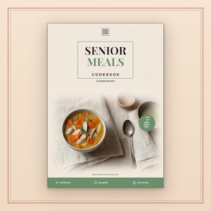 May include: A cookbook titled Senior Meals Cookbook with 20 senior recipes. The cover features a bowl of soup with carrots and chicken, a silver spoon, and a small wooden bowl. Text includes DD, Senior Meals, Cookbook, 20 Senior Recipes, Easy Tasty Kind, and Nutritious Balanced Supportive.