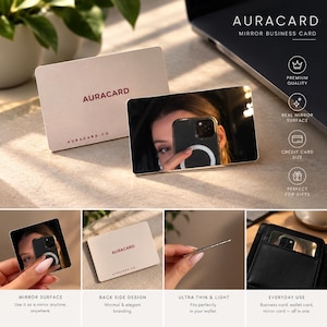May include: A rectangular mirror business card with a reflective surface and a matte beige back featuring the text AURACARD and auracard.co. The card is credit card sized, ultra-thin, and designed for use as a portable mirror or business card.