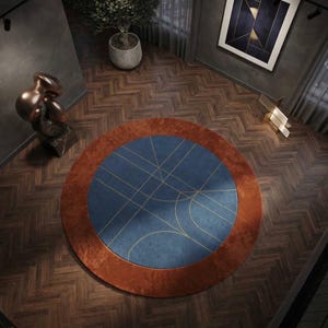 May include: A circular area rug featuring a deep blue center with thin, intersecting gold lines forming a geometric pattern, surrounded by a wide, solid burnt orange border. The rug is positioned on a dark brown wooden floor with a herringbone pattern.