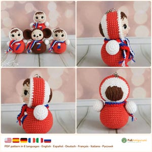 May include: A collection of small, round, crocheted dolls featuring a central brown character with large ears and several red, white, and blue figures. Each doll has a keychain attachment, a round body, and a hood. The dolls feature embroidered facial details.
