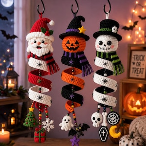 May include: Three hanging crochet ornaments featuring a Santa Claus, a jack-o'-lantern, and a skeleton, each wearing a hat and scarf. Below each figure is a spiral crochet tail decorated with small charms including a tree, gift, ghost, bat, skull, and coffin.