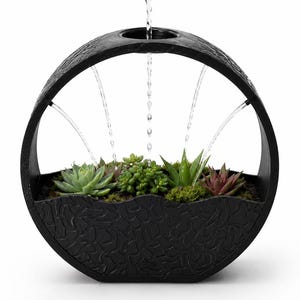 May include: A circular black water fountain with a textured surface containing a variety of green and reddish succulents planted in soil. Water flows from the top center of the circular frame, creating multiple streams that fall into the planter.