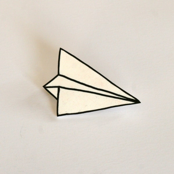White plastic paper plane brooch