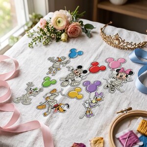 May include: A collection of die-cut paper stickers featuring Disney characters wrapped in white mummy bandages, each holding a solid-colored balloon shaped like a Mickey Mouse head. The characters include Mickey, Minnie, Donald, Daisy, Goofy, and Pluto.