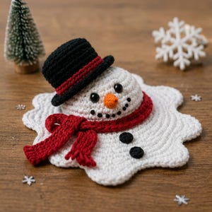 May include: A crocheted melting snowman ornament featuring a white textured base, a black top hat with a red band, a bright red scarf, an orange carrot nose, black bead eyes, a stitched black mouth, and two black buttons on the white body.