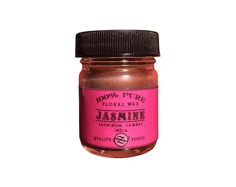 May include: A small glass jar with a black lid containing 100% pure floral wax jasmine. The label is pink and reads "100% Pure Floral Wax Jasmine, Jasminum Sambac India, Quality Tested".