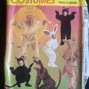 May include: A McCall's sewing pattern envelope for costumes labelled P386. The front displays five full-body animal costumes: a tan lion, a black bear, a white rabbit, a black cat, and a leopard. The text includes 'McCall's Costumes' and 'Easy to Sew'.