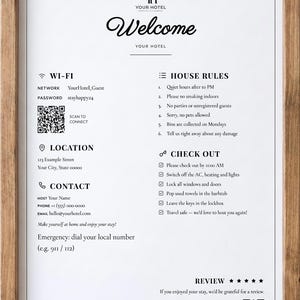 May include: A framed hotel welcome sign with a wooden border. The white document features black text including Wi-Fi details, house rules, location, contact information, check-out instructions, and two QR codes for connecting to Wi-Fi and leaving a review.