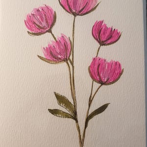 May include: A greeting card featuring a watercolor illustration of five vibrant pink flowers with dark green stems and leaves. The petals are painted with visible brushstrokes, and the artist's signature, Donna, is written in black ink in the bottom right corner.