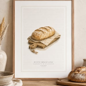 Può includere: Una stampa artistica incorniciata con un'illustrazione dettagliata di una pagnotta dorata appoggiata su un panno chiaro sopra un piccolo tagliere di legno. Il testo RUSTIC BREAD LOAF è stampato in nero nella parte inferiore dell'immagine.