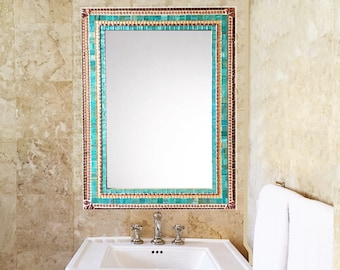 May include: A white porcelain bathroom sink with a chrome faucet and a mirror with a turquoise and gold mosaic tile frame.