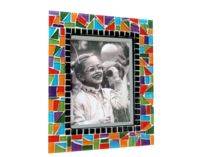 May include: A rectangular photo frame with a mosaic border. The mosaic is composed of colorful glass tiles in shades of red, orange, blue, green, and purple. The frame holds a black and white photograph of a person wearing glasses.