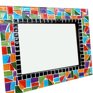 May include: A rectangular mosaic mirror with a vibrant, colorful border. The mosaic design features an array of geometric shapes in red, orange, green, blue, and purple. The frame is accented with black tiles.