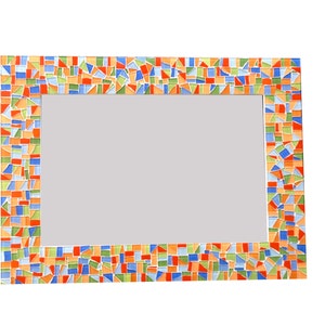 May include: A rectangular mirror with a colorful mosaic frame. The frame is made of small, irregular pieces of tile in shades of orange, blue, green, and white.
