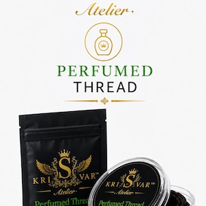 May include: A black pouch and a clear circular container holding dark thread, both labeled with the gold and green KRI S VAR Atelier Perfumed Thread Moutabbor Collection logo, featuring a crown, wings, and a perfume bottle icon above the text.