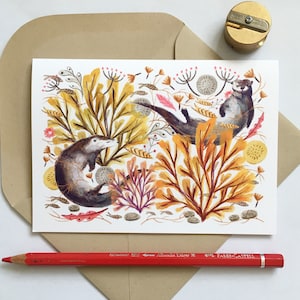 May include: Watercolor illustration of two otters swimming in a bed of yellow, orange, and brown seaweed. The otters are brown with white bellies and are surrounded by pink and purple flowers.