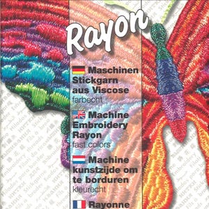 May include: A vibrant, multi-colored embroidered butterfly design featuring shades of red, orange, purple, blue, and green. The word Rayon is printed in white at the top, followed by text in German, English, and Dutch describing machine embroidery thread.
