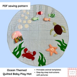 May include: A round quilted play mat with a blue and white pinstripe pattern featuring fabric appliques of a red crab, a brown turtle, a peach starfish, a pink jellyfish, and small fish. The text PDF sewing pattern is visible.