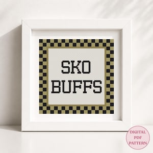 May include: A square cross stitch pattern featuring the black text SKO BUFFS centered on a white background. The design is enclosed by a gold and black checkered border, all displayed within a simple white frame. A digital PDF pattern label is visible.