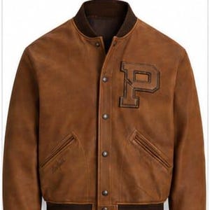 May include: A brown leather varsity jacket featuring a dark brown ribbed collar, cuffs, and hem. The jacket has a front snap-button closure and a large, dark brown letter P patch on the left chest. Two slanted welt pockets are located at the waist.