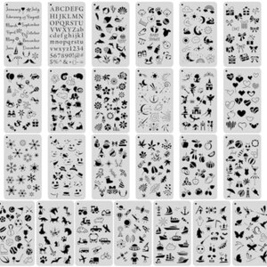 May include: A collection of twenty-four rectangular plastic stencils featuring black cut-out designs including letters, numbers, seasonal motifs, animals, space themes, nautical icons, sports equipment, and various holiday-themed patterns.