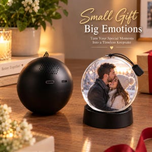 May include: A black spherical speaker with a USB-C port and a circular glass ornament displaying a photograph of a couple embracing. The text "Small Gift Big Emotions" and "Turn Your Special Moments Into a Timeless Keepsake" is visible above.