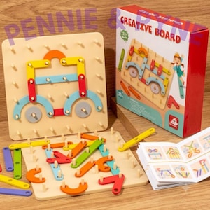 May include: A wooden pegboard construction set featuring a square board with pegs, colorful geometric plastic pieces in red, yellow, blue, orange, and green, a box labeled CREATIVE BOARD, and an instruction booklet with pattern examples.