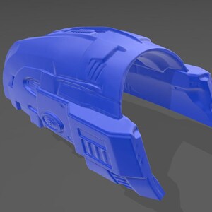 May include: A bright blue, curved, semi-cylindrical armour component featuring intricate geometric paneling, recessed rectangular vents, and a circular embossed detail on the side, presented as a solid, singular moulded piece with a smooth finish.