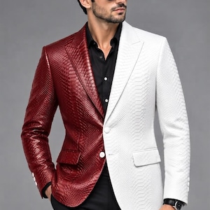 May include: A two-tone blazer featuring a split design with a deep red side and a white side, both displaying a textured snakeskin-like pattern. The garment includes a notched lapel, two front buttons, and two flap pockets on the lower front.
