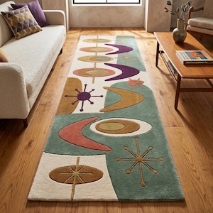 May include: A rectangular area rug featuring a repeating pattern of abstract shapes including boomerangs, starbursts, and concentric ovals in shades of teal, mustard yellow, burnt orange, and purple on a cream-colored background with a plush texture.