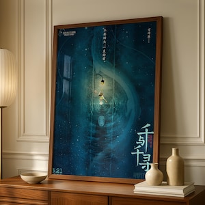 May include: A framed movie poster for Spirited Away featuring a deep blue, watery background with a small figure, a glowing lantern, and a white mask-like face. The poster includes Chinese text, the title, and the date 3.21 in the bottom corner.