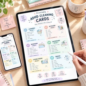 May include: A digital tablet and smartphone displaying printable ADHD cleaning cards with six color-coded sections for household tasks. The cards feature checklists for laundry, kitchen, bedroom, bathroom, living room, and quick resets in A4 size.