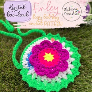 May include: A round crochet bag featuring a bright green base with a white middle layer and a vibrant magenta and yellow flower centre. The bag includes a long green crochet strap. Text on the image reads: digital download, Finley loopy loot bag crochet PATTERN, The Loopy Momma.