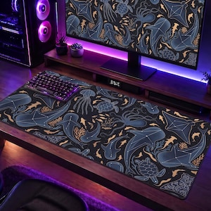 May include: A large rectangular desk mat featuring a dark navy blue background with a repeating pattern of sea creatures including sharks, sea turtles, jellyfish, and rays, all outlined in thin white lines resembling constellations.