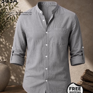 May include: A grey long-sleeve shirt with a mandarin collar, a front button placket, and a single chest pocket. The sleeves are rolled up and secured with small buttons. Text on the image reads: CREATED FOR PRIMETHREAD SUSA, Head Executive, Polero Builders Inc. 11 Olive Rd. Huntington Station, NY.
