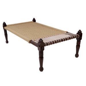 May include: A rectangular daybed featuring a dark brown wooden frame with four turned legs. The sleeping surface is constructed from woven beige rope in a diamond pattern, with a section of white rope tensioning at one end of the frame.